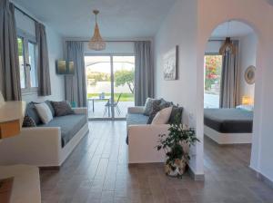 a living room with a couch and a table at Rhodes Soul luxury suites in Afantou