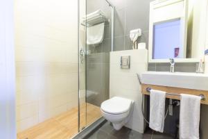 a bathroom with a toilet and a sink and a shower at Downtown River Apartments in Tbilisi City