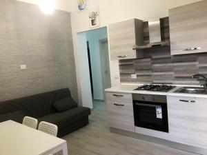 a kitchen and living room with a stove and a couch at One bedroom house with sea view enclosed garden and wifi at Ribera 5 km away from the beach in Ribera