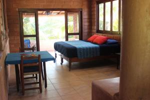 a bedroom with a bed and a table and a table and chairs at Ocean Front Paradise in Petatlán +18 photos