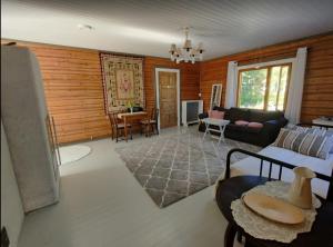a living room with a couch and a table at VillaTorppa in Jämsä
