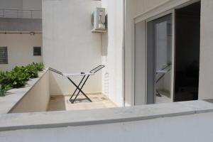 a chair sitting on the balcony of a building at Relaxing Vacation Stay in Mahdia in Rejiche