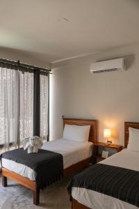 Postel nebo postele na pokoji v ubytování Hotel Muyu Tulum