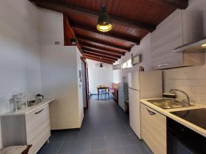 a kitchen with a sink and a refrigerator at Terrazza San Camillo in Catania