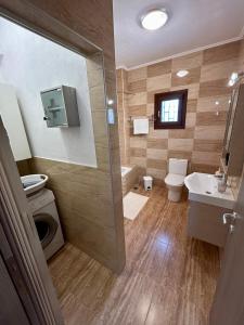 a bathroom with a shower and a toilet and a sink at My Bright House in Afitos +51 photos
