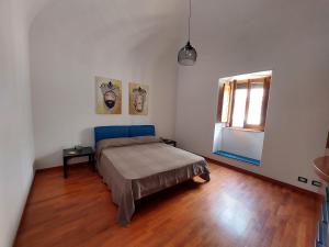 a bedroom with a bed and a window at Terrazza San Camillo in Catania