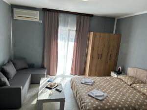 a room with a bed and a couch and a table at Villa Stanišić in Boreti