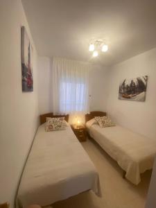 a room with two beds and a window at Tu Oasis lujoso en Marina d Or in Oropesa del Mar +29 photos