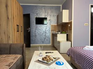 a living room with a table and a kitchen at Villa Stanišić in Boreti