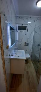 a bathroom with a sink and a mirror at Vila Andoni in Qeparo +57 photos