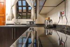 a kitchen with a counter with a toaster on it at acaciaoptimumstay in Gaborone