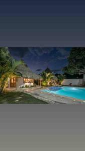 two pictures of a house and a swimming pool at Villa el Oasis, luxurious Santa Marta getaway in Santa Marta