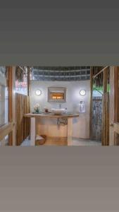 a room with a table with a mirror and a sink at Villa el Oasis, luxurious Santa Marta getaway in Santa Marta