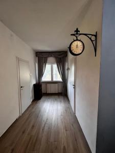 una stanza vuota con un orologio sul muro di Agriturismo Villa Paradiso - appartamenti con piscina a Fauglia