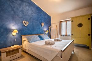 a bedroom with a bed with towels on it at Dery Alghero Holiday La Torre in Alghero
