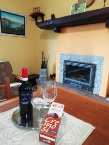 a bottle of wine and two glasses on a table at Chalet Niki BELLAGIO in Bellagio