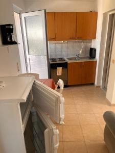 a kitchen with a refrigerator and a counter top at Apartman Bari Petrcane in Petrcane