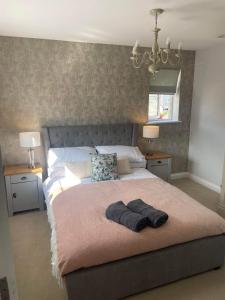 a bedroom with a large bed with two tables and two lamps at Number 1 Longstone Court in Haverfordwest