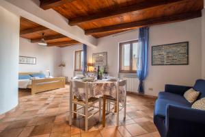 a living room with a table and a couch at Alghero Gilbert Ferret in Alghero +34 photos