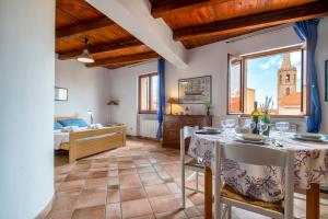 a living room with a table and a bedroom at Alghero Gilbert Ferret in Alghero