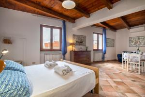 a bedroom with a bed and a dining room at Alghero Gilbert Ferret in Alghero