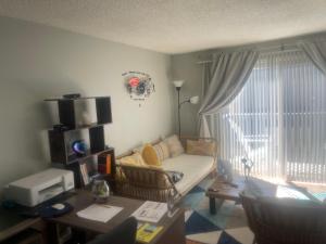 a living room with a couch and a window at Shared Space with Private room in Beautiful Lakefront Apartment in Federal Way