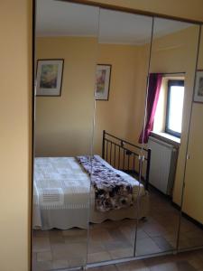 A bed or beds in a room at La Perla del Lago di Como - CIR O97O67