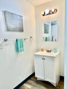 a bathroom with a white sink and a mirror at Studio Apartment with Shared Bathroom 10 minutes walk to University of WA in Seattle