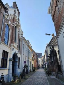 a cobblestone street in a city with buildings at B&B Noviomagus in Nijmegen