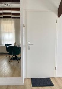 an open door leading into a room with a table at CITYNA Apartment Bielefeld in Bielefeld