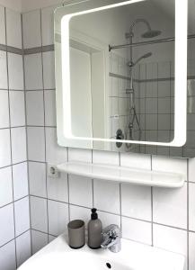 a bathroom with a sink and a mirror on the wall at CITYNA Apartment Bielefeld in Bielefeld
