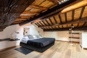 a bedroom with a bed in a room with wooden ceilings at Rooftop Campo dei Fiori in Rome