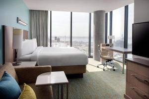 a hotel room with a bed and a desk and a television at SpringHill Suites by Marriott San Diego Downtown/Bayfront in San Diego