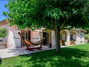 a hammock under a tree in front of a house at Villa Hibiscus in Antibes