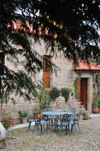 a table and chairs in front of a building at Quinta de Lourosa in Lousada