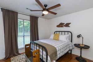 a bedroom with a bed and a ceiling fan at Abigail's Lake Haven in Jacksons Gap
