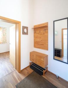 a room with a mirror and a wooden dresser at Eistobel und Felderhalde in Isny im Allgäu