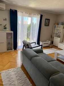 a living room with a couch and a window at Apartment Frane in Kaštela