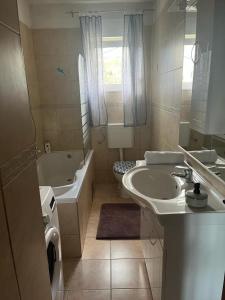 a bathroom with a sink and a tub and a toilet at Apartment Frane in Kaštela