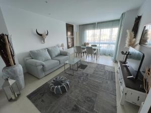 a living room with a couch and a table at La Bovila Apartment with exceptional yard in Platja  d'Aro