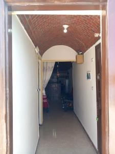 a hallway leading into a room with a brick ceiling at Merit Roof Apartment in Hurghada