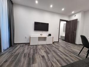 a living room with a flat screen tv on a wall at Apartment's Ortakchiev in Sofia