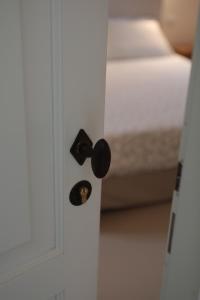 a door with a door knob on a room with a bed at Agriturismo I Casali in Fiumaretta di Ameglia +9 photos