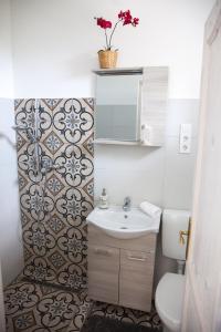 a bathroom with a sink and a toilet at Turquoise Lake Guesthouse Balaton in Balatonszárszó +7 photos