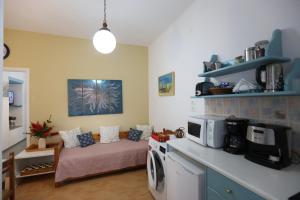 a living room with a bed and a microwave at Bella Vista in Batsi +14 photos