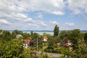 a view of a town with houses and the water at Turquoise Lake Guesthouse Balaton in Balatonszárszó