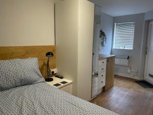 1 dormitorio con 1 cama, vestidor y escritorio en 228 Cinderhill Road en Nottingham