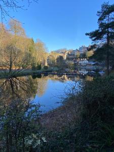 a view of a river with a bridge in the background at Claro Mews Gem in Knaresborough