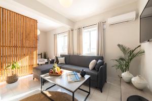 a living room with a couch and a table at Emelia Cozy Apartment in Rhodes Town