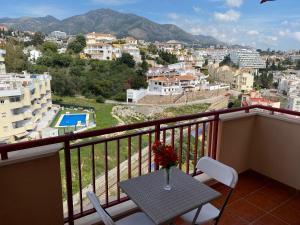 a balcony with a table and a view of a city at Studio in Costa Del Sol, Sea, Sunshine & Views in Fuengirola